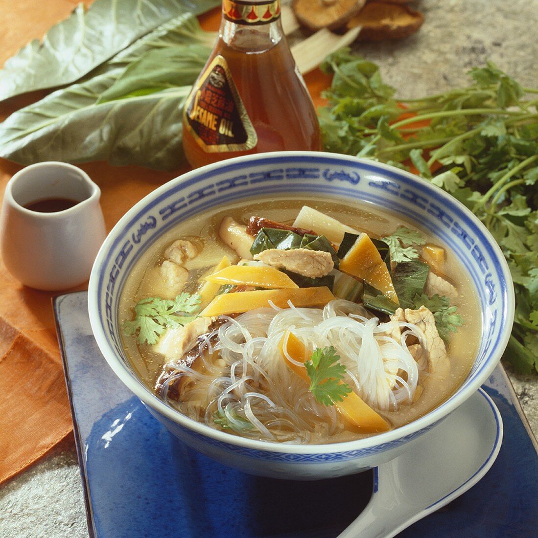 Hot and sour soup with glass noodles, vegetables and meat