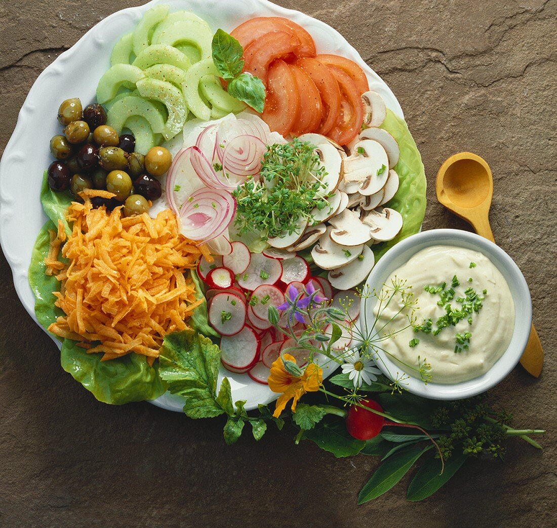 Colourful mixed raw vegetable salad with aioli