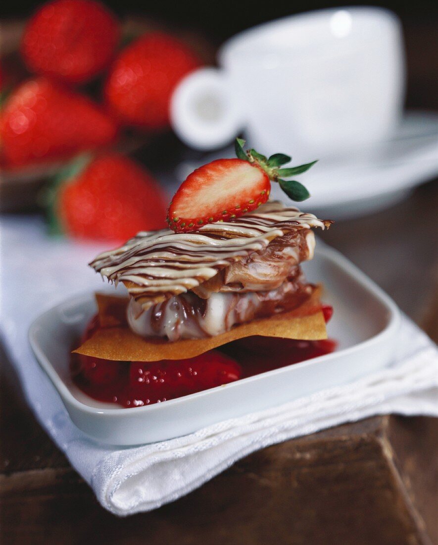 Marbled chocolate cream on strudel pastry and strawberries