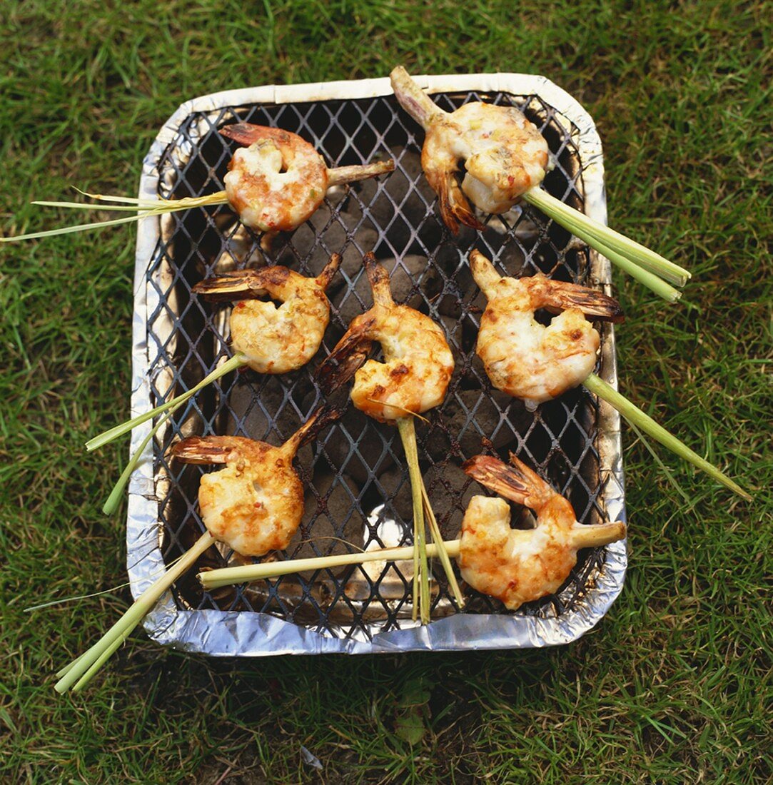 Marinated prawns on lemon grass skewers on barbecue
