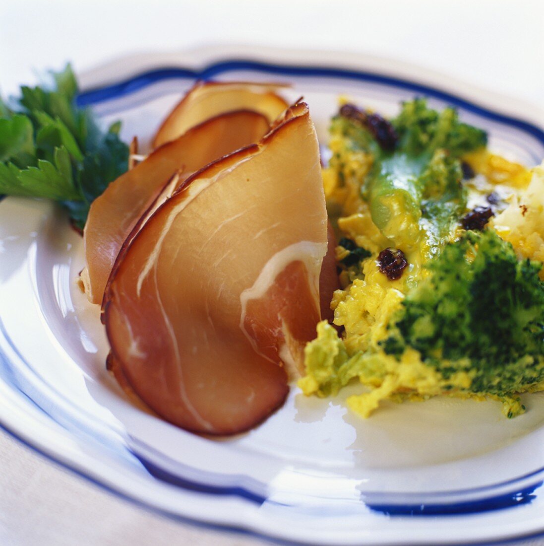 Raw ham with warm scrambled egg and cabbage