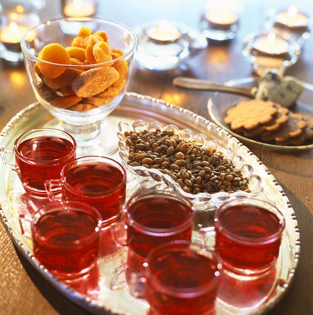 Warm cranberry punch and sweet nibbles on a tray