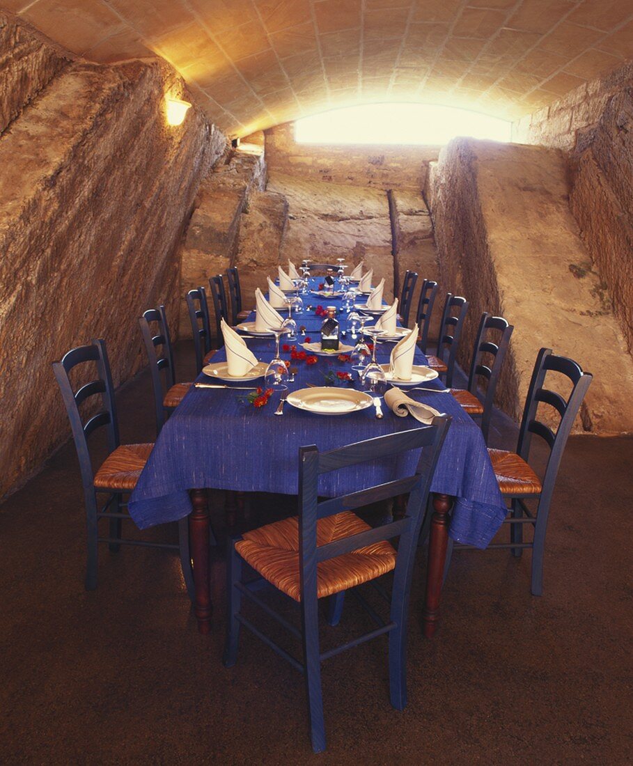 Table laid for special occasion in a vaulted cellar