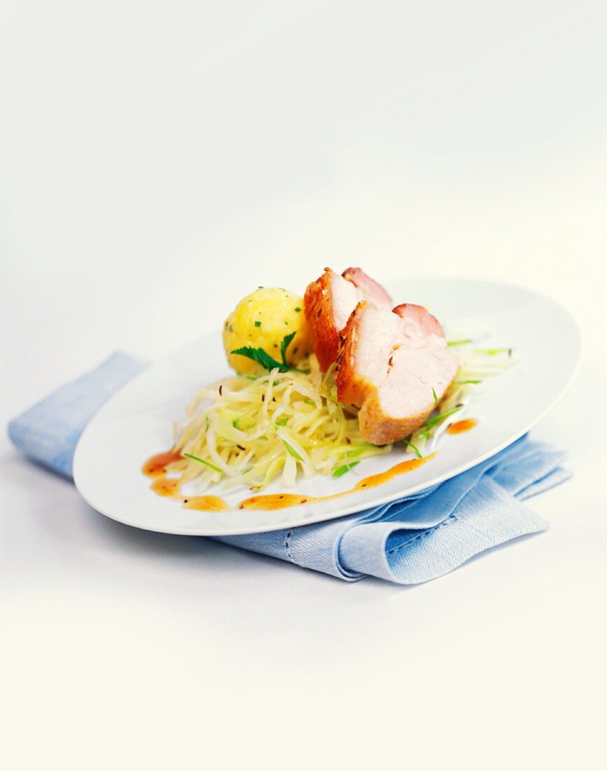 Roast pork with dumpling and white cabbage
