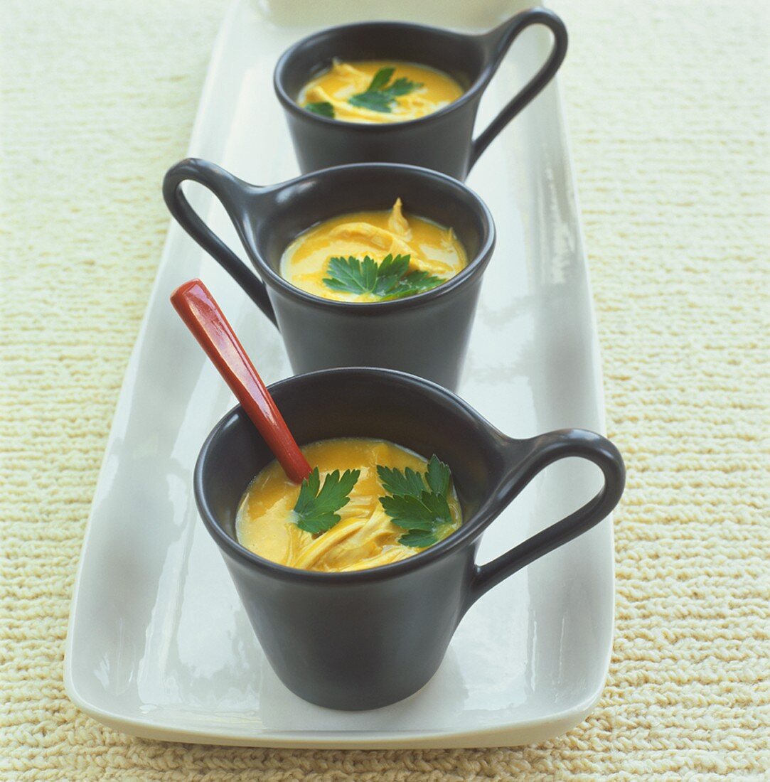 Fish soup in three black cups