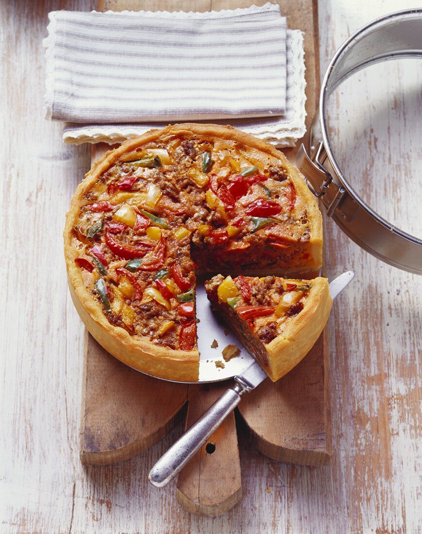 Mince and pepper quiche on a wooden board