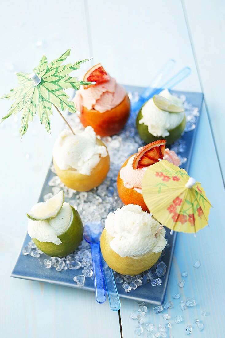 Various types of fruit ice cream with cocktail umbrellas
