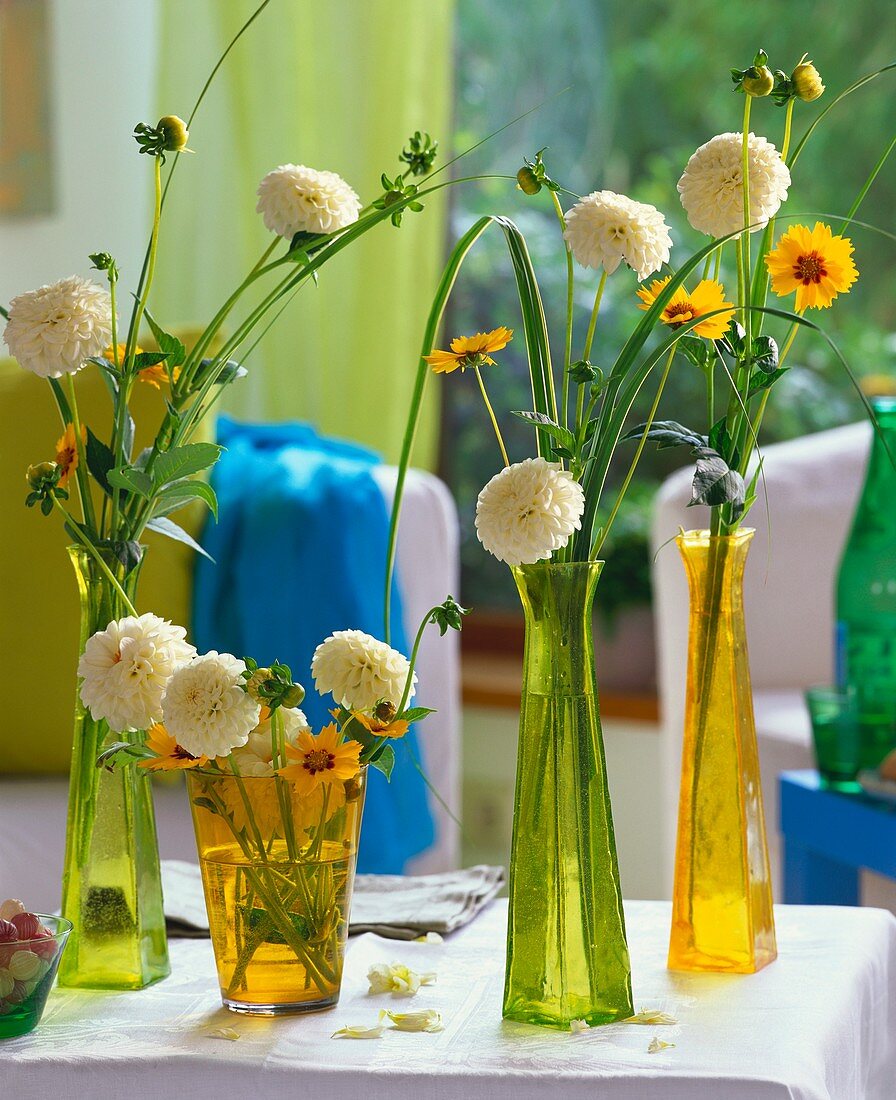 White ball dahlias with coreopsis & prairie cordgrass in vases