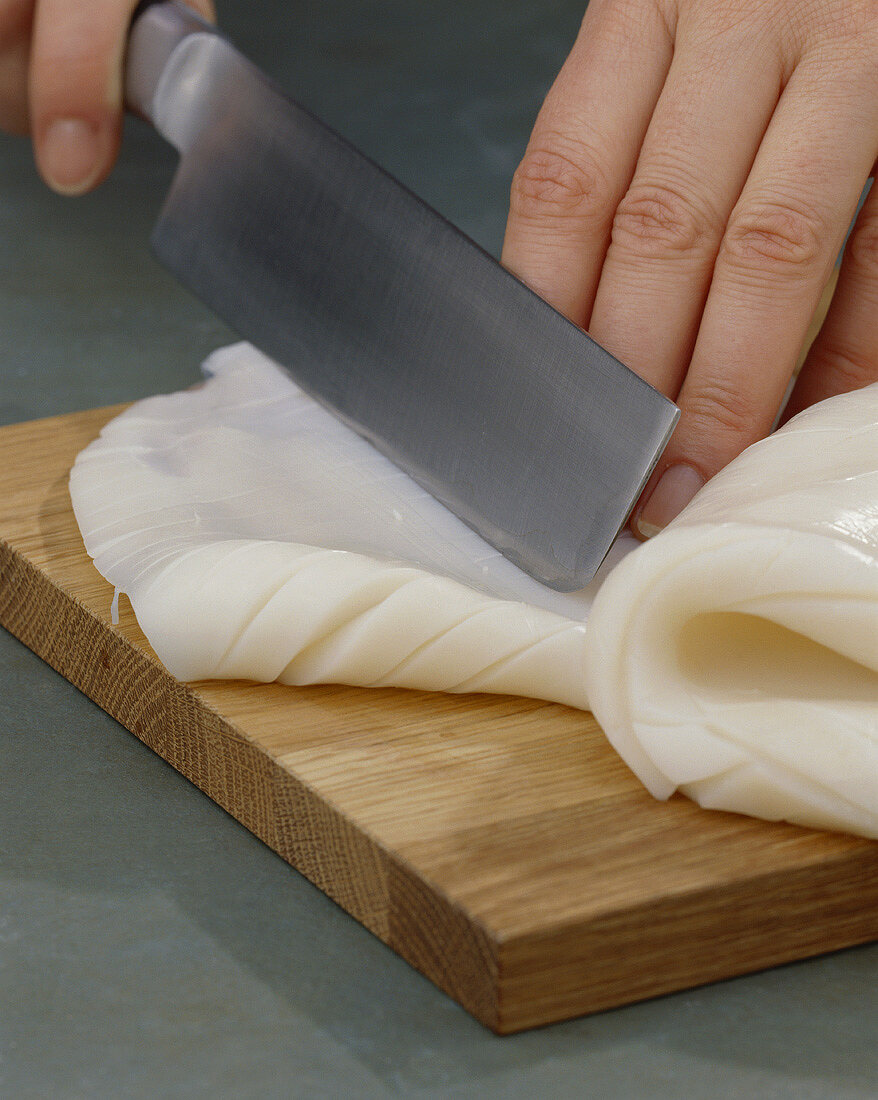 Scoring cuttlefish in a diamond pattern with a sharp knife