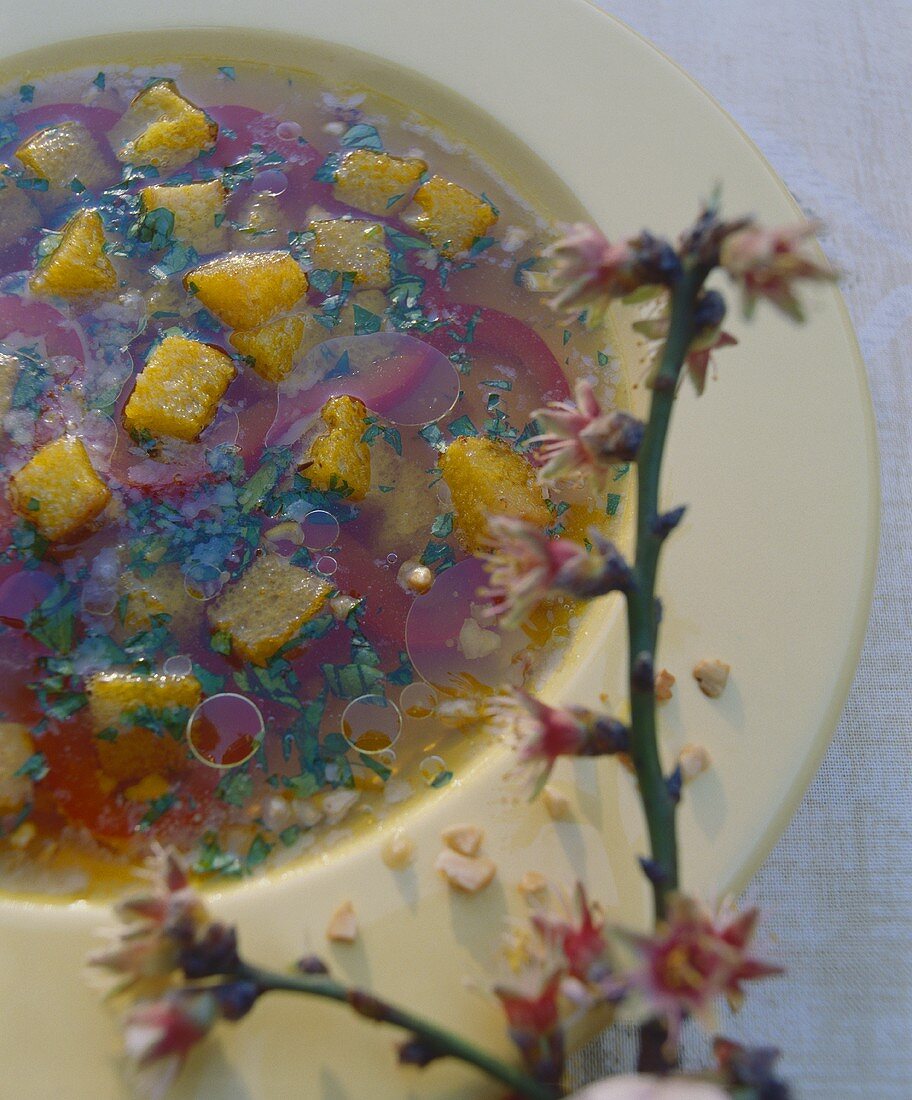 Almond soup with saffron, strips of red pepper & bread cubes