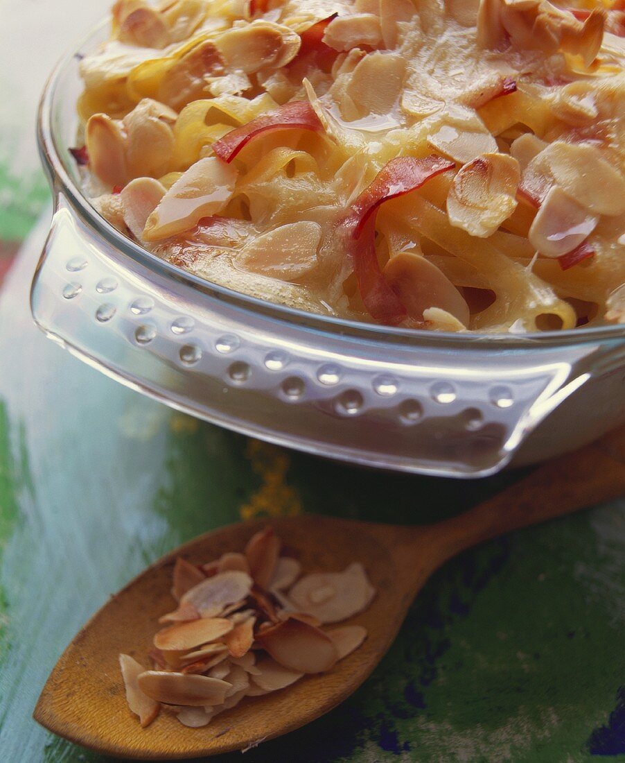 Pasta bake with strips of ham and flaked almonds