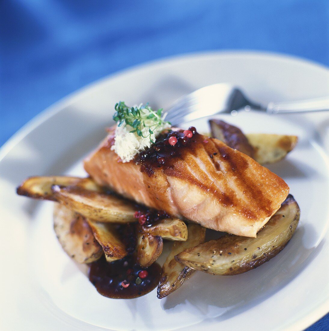 Grilled salmon with potatoes, pepper sauce, horseradish