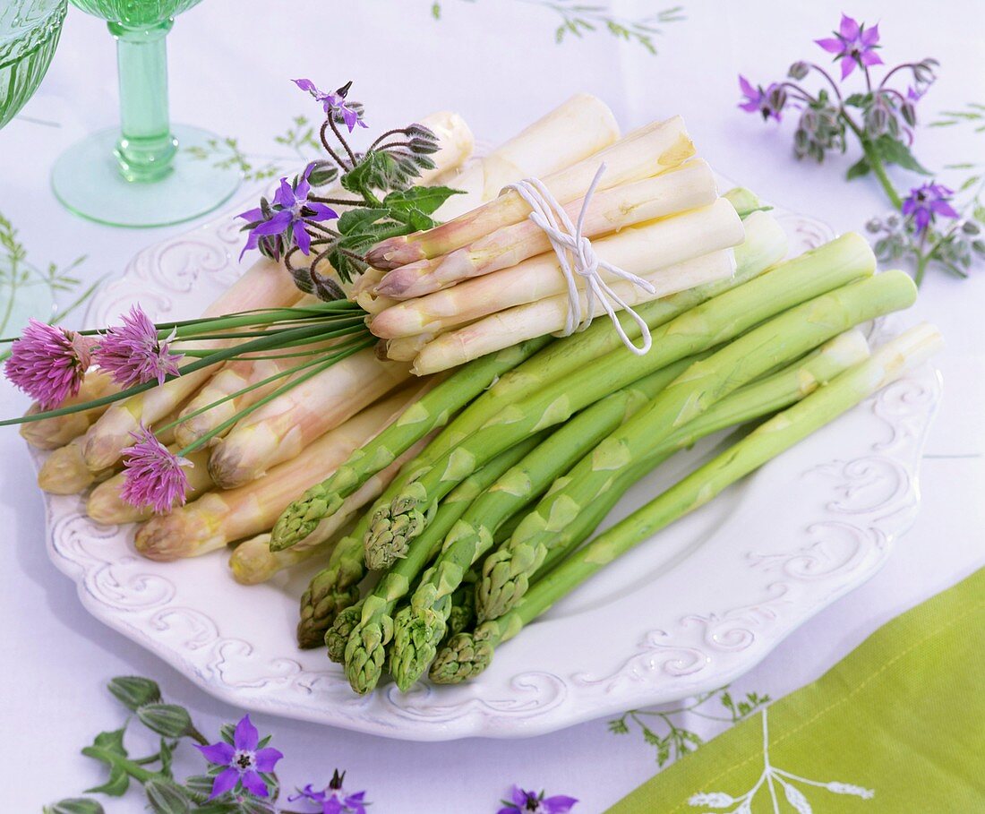 Plate of white and green asparagus, chives and borage