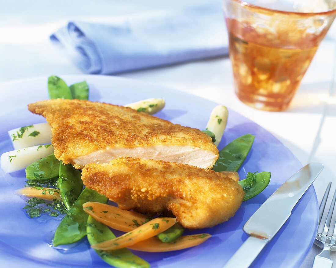 Breaded chicken escalope on vegetables