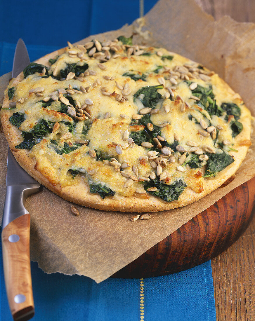 Bergkäse cheese and spinach pizza with sunflower seeds