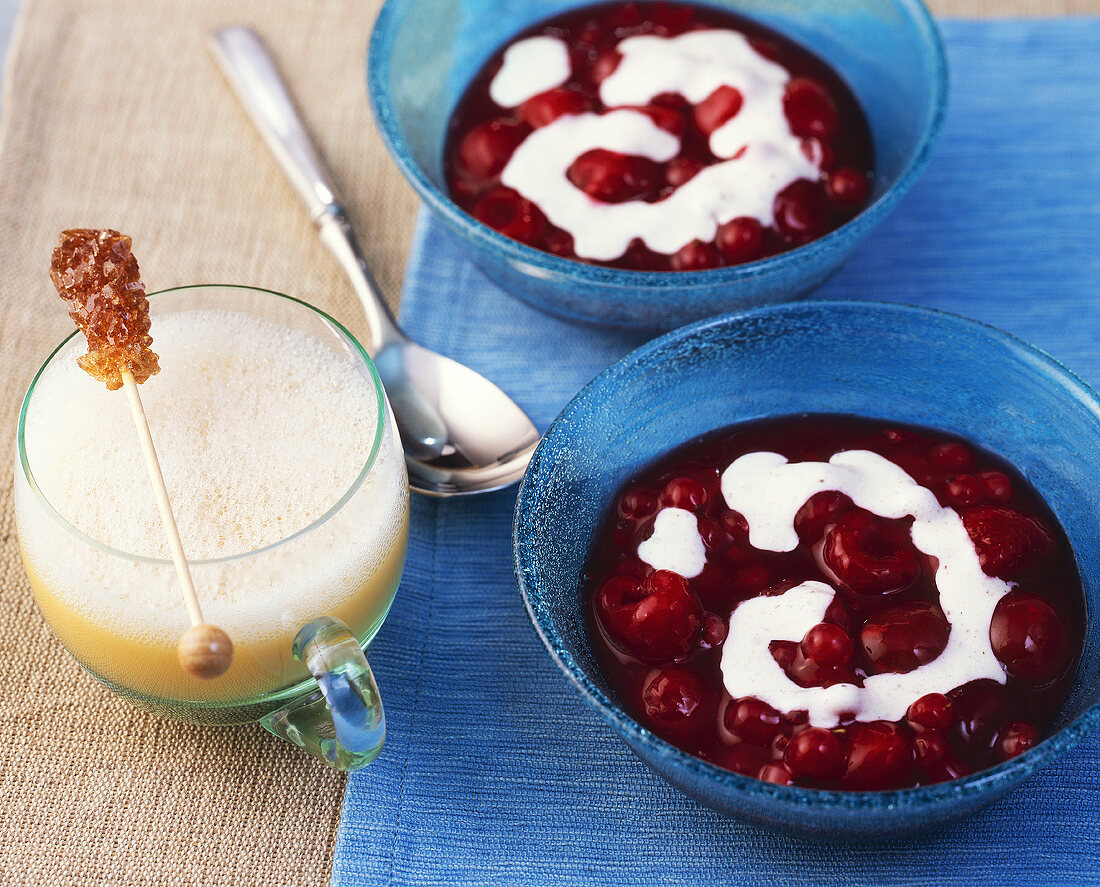 Red fruit compote with custard & eggnog with sugar swizzle stick