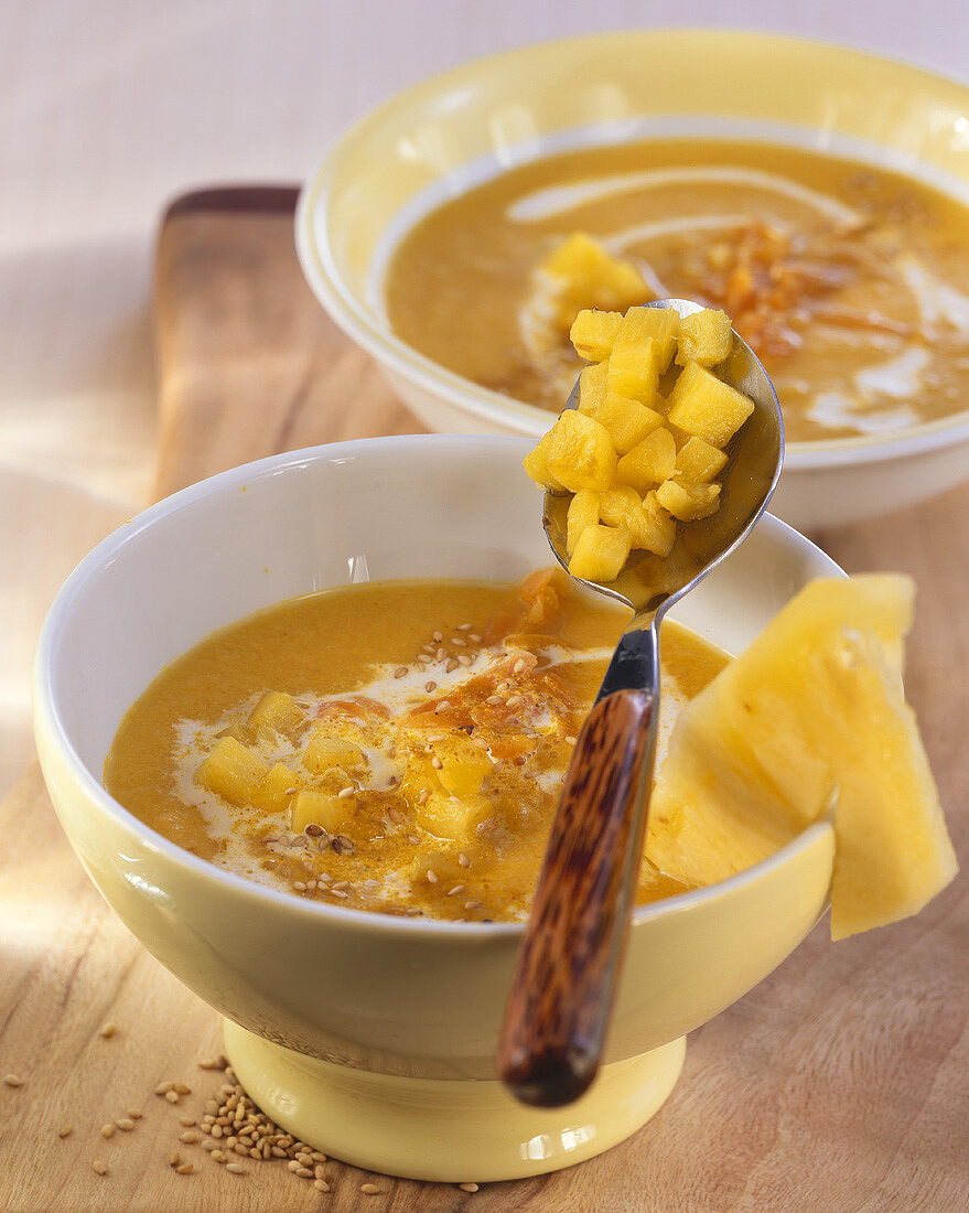 Carrot and ginger soup with pineapple and sesame seeds