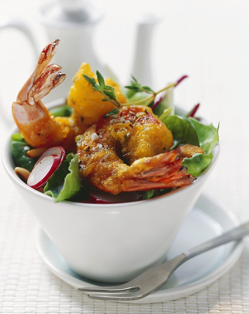 Deep-fried prawns in tempura batter on mixed salad