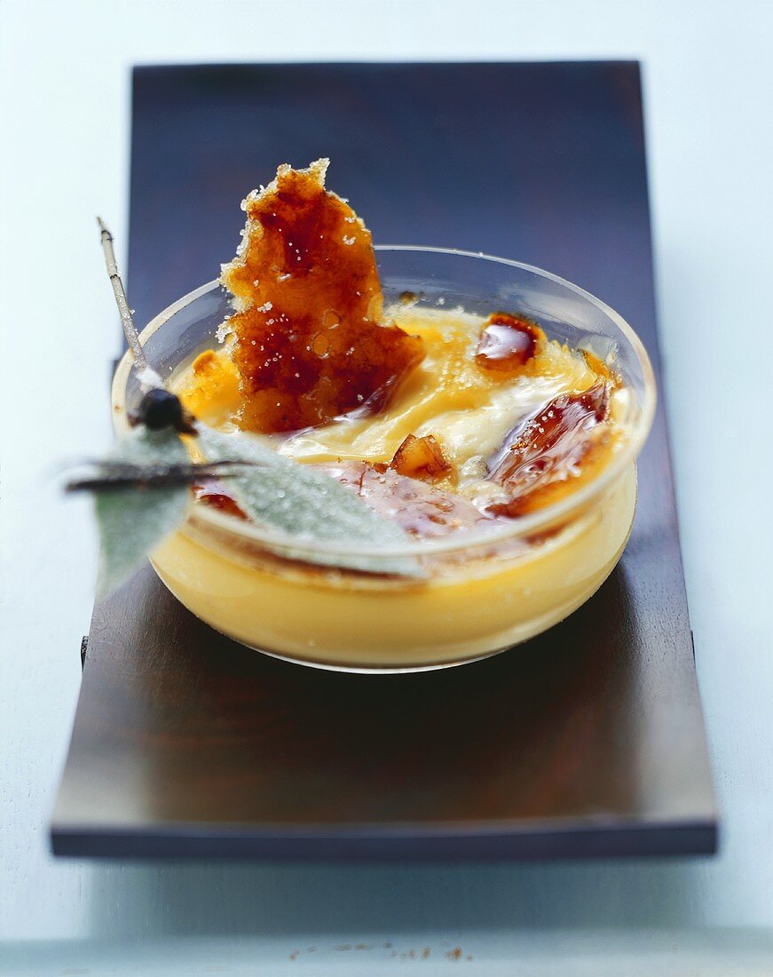 Crème brûlée with rosemary in glass dish