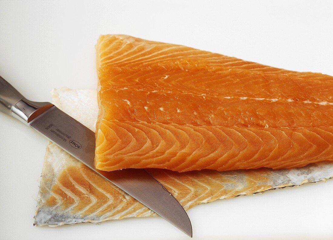 Removing the skin & fat layer from salmon fillet with knife