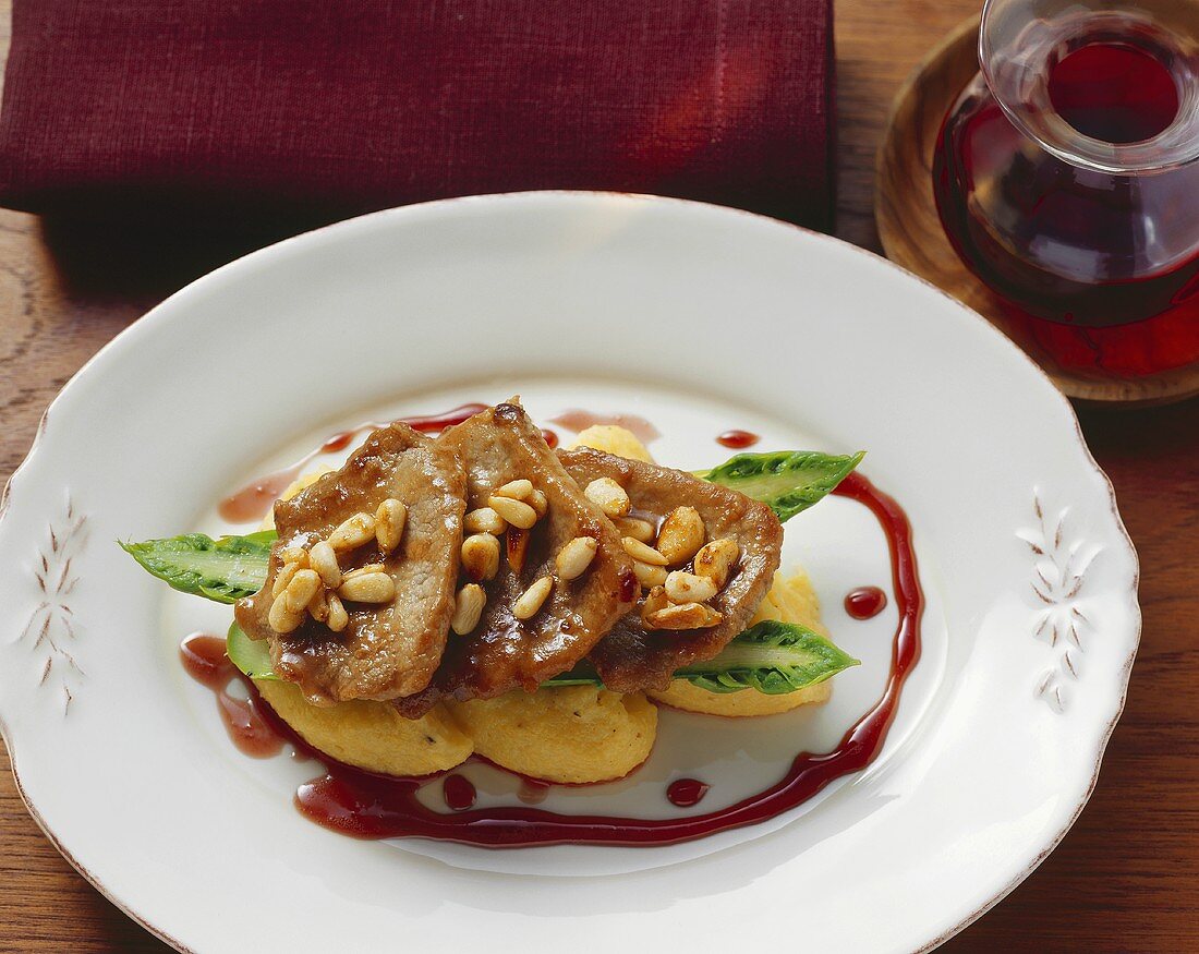 Scaloppine with pine nuts on polenta dumplings (Italy)