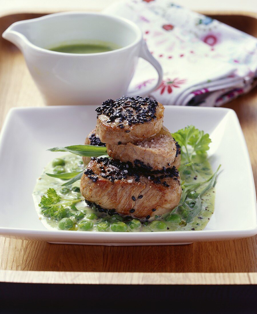 Pork fillet with young peas, tarragon & black sesame seeds