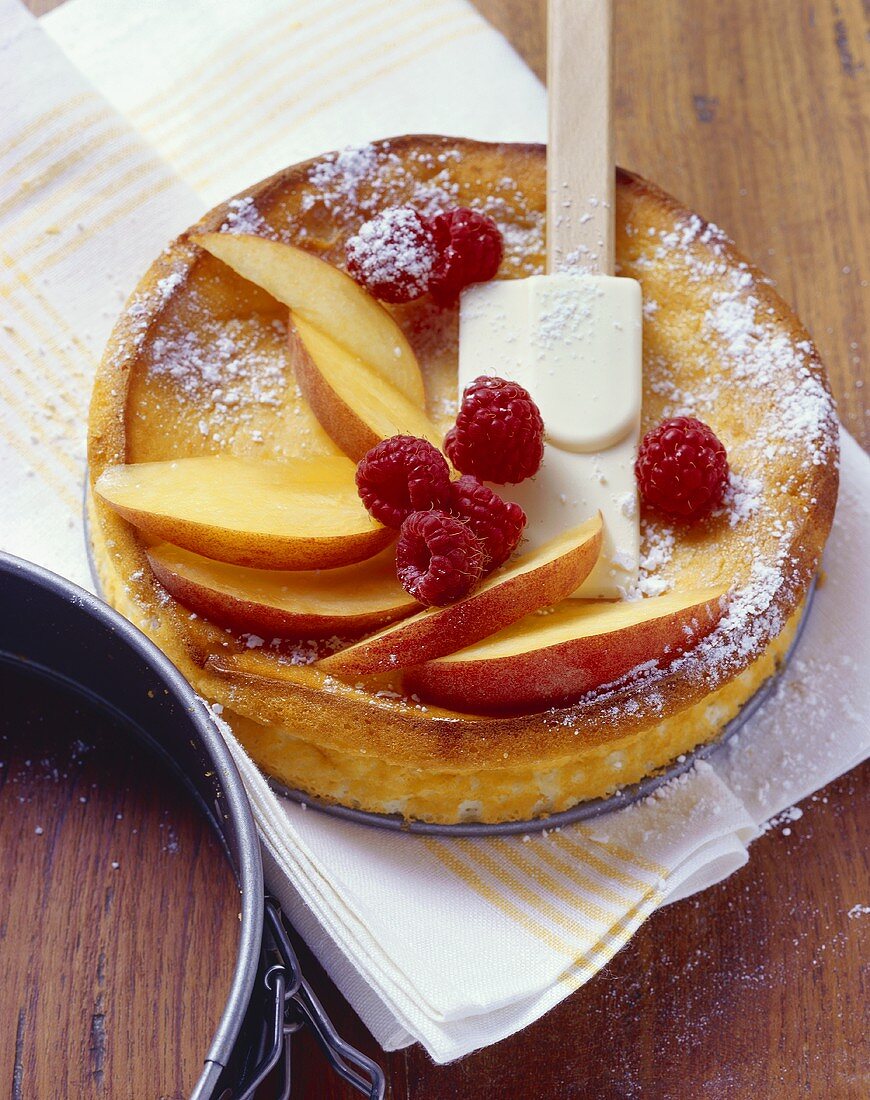 Baked quark cake with peaches and raspberries