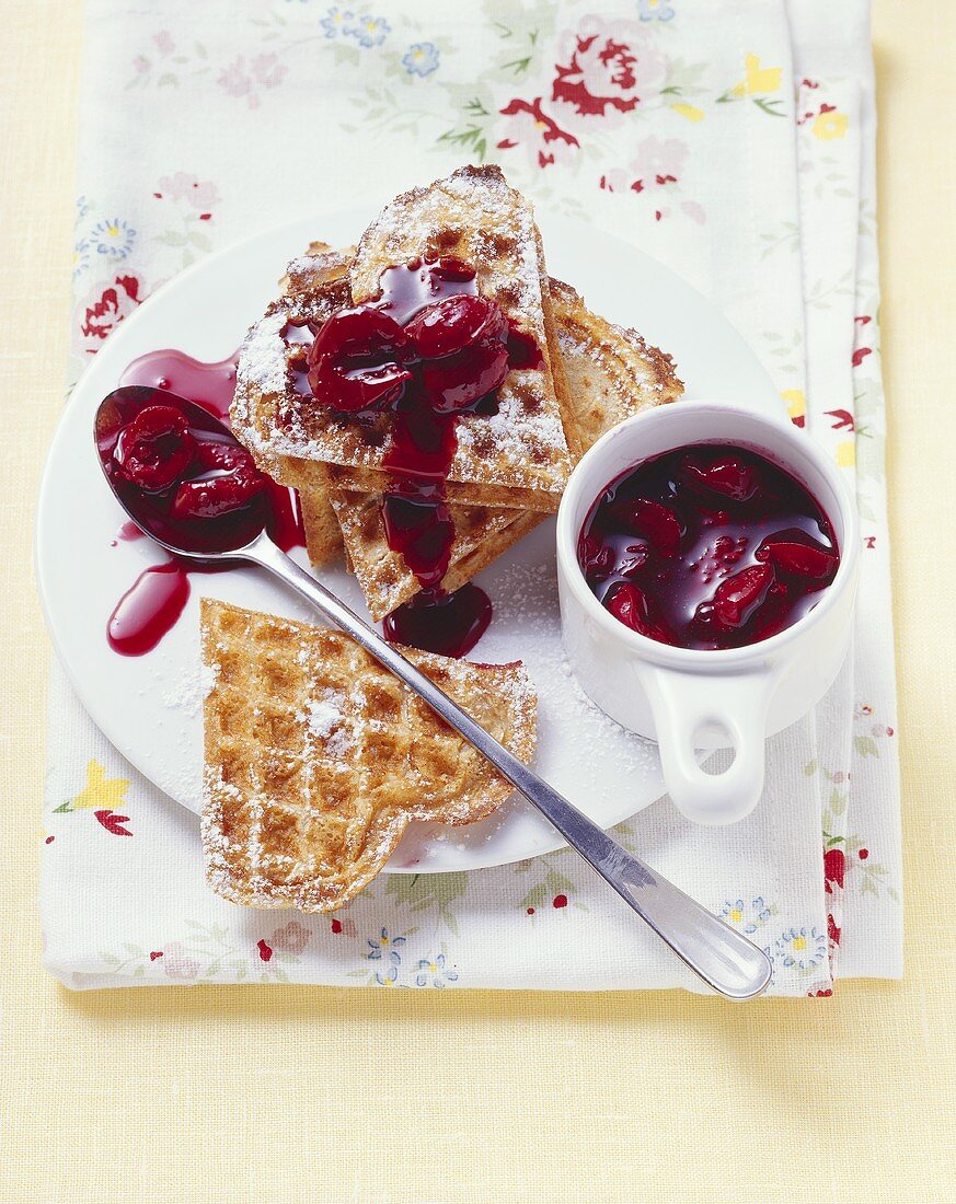 Sour cream waffles with cherries and bitter chocolate
