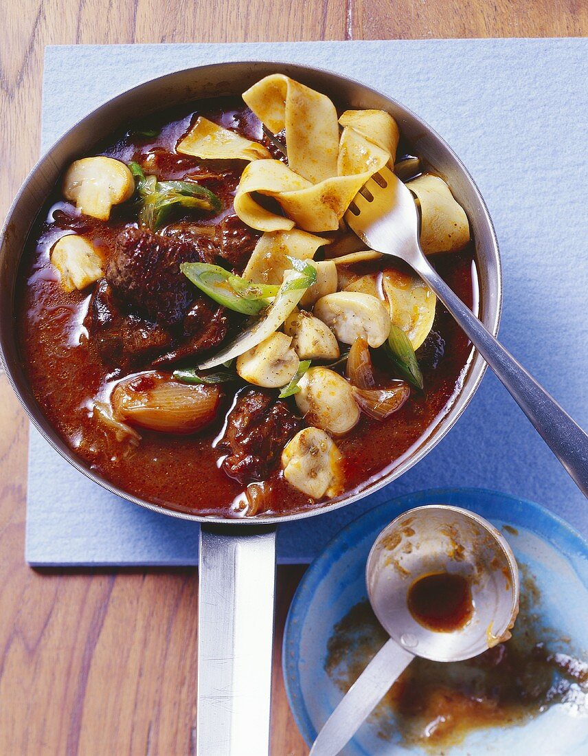Red wine goulash with shallots and mushrooms