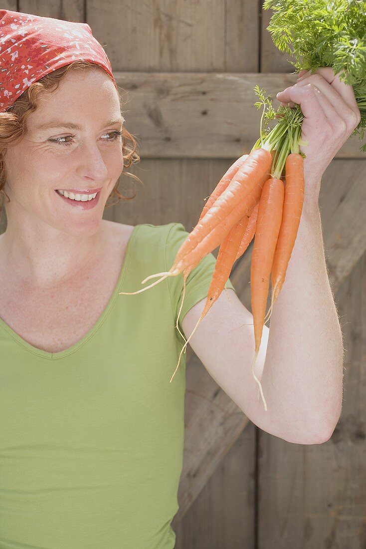 Young woman with carrots