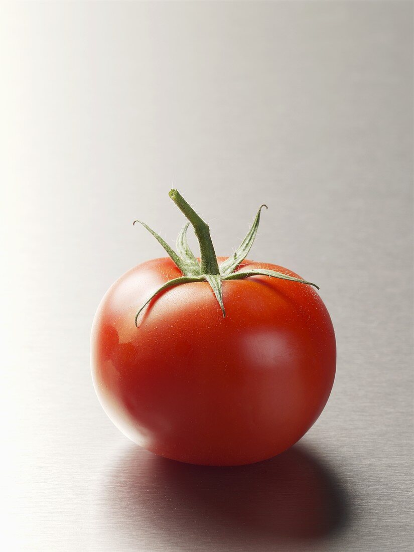 A tomato on stainless steel