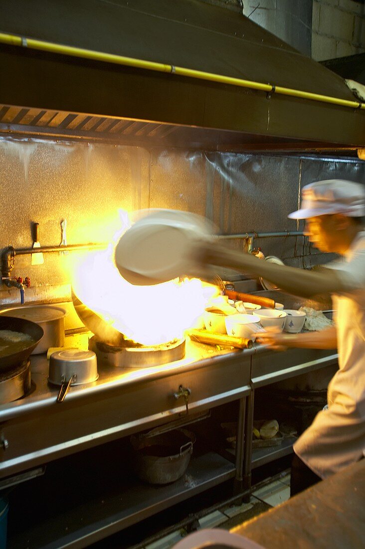 Asian chef with wok (Thailand)