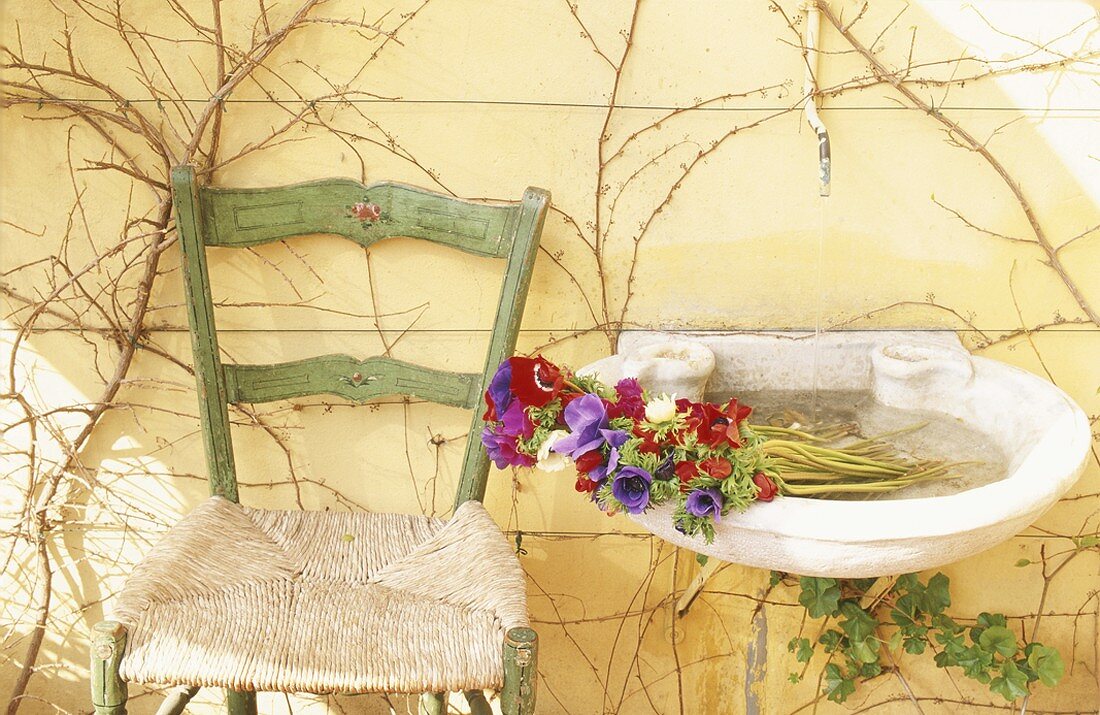 Bouquet in washbasin next to chair