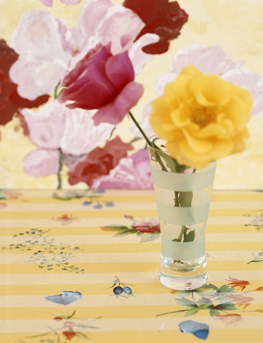 Multicoloured roses in drinking glass