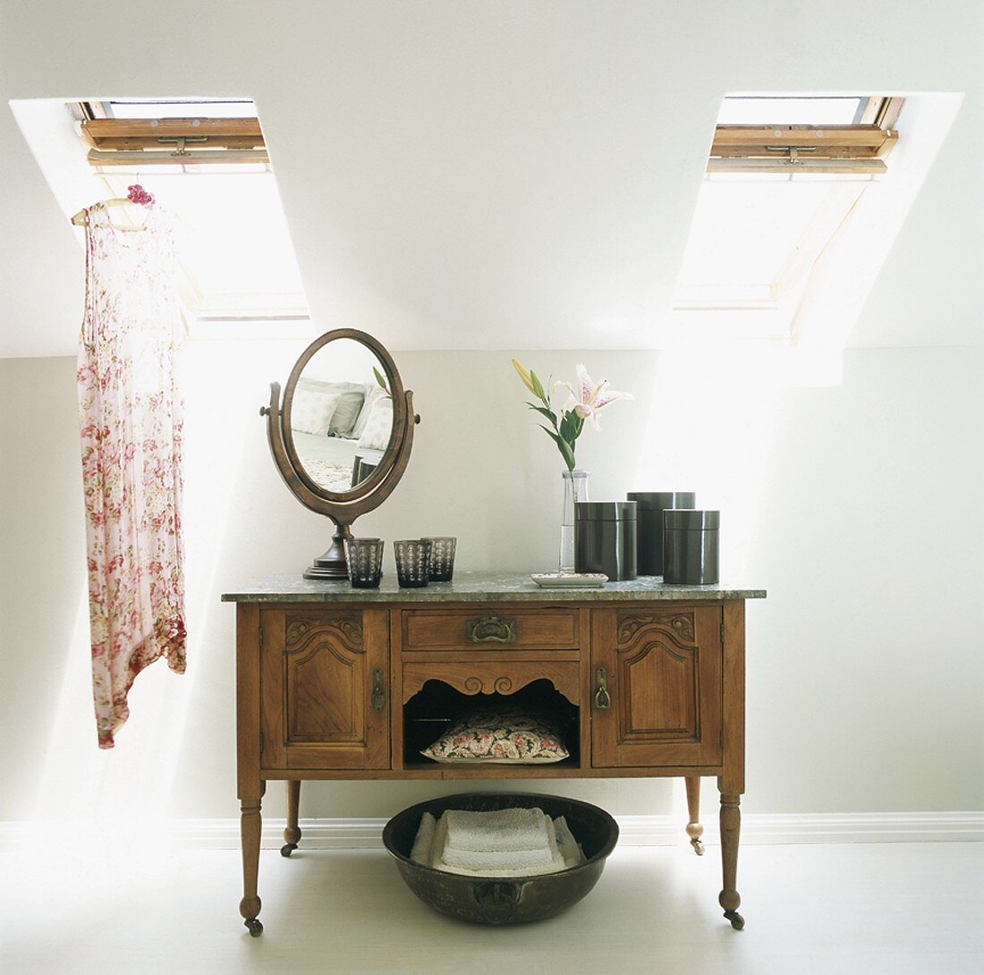 Mirror and containers on an old sideboard