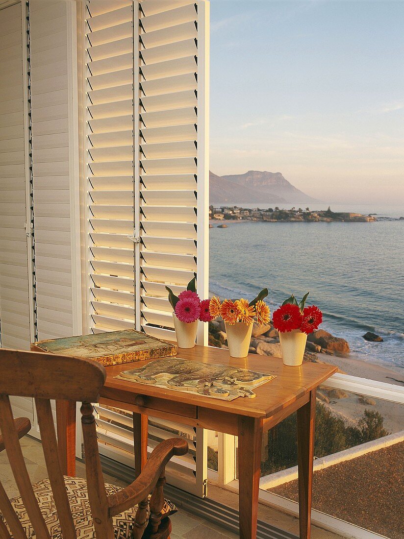 View of sea and coastal landscape through sliding window