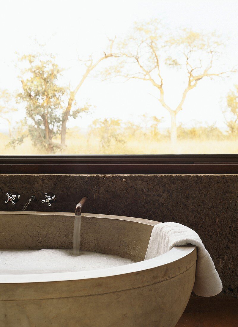 Stone bathtub being filled with water