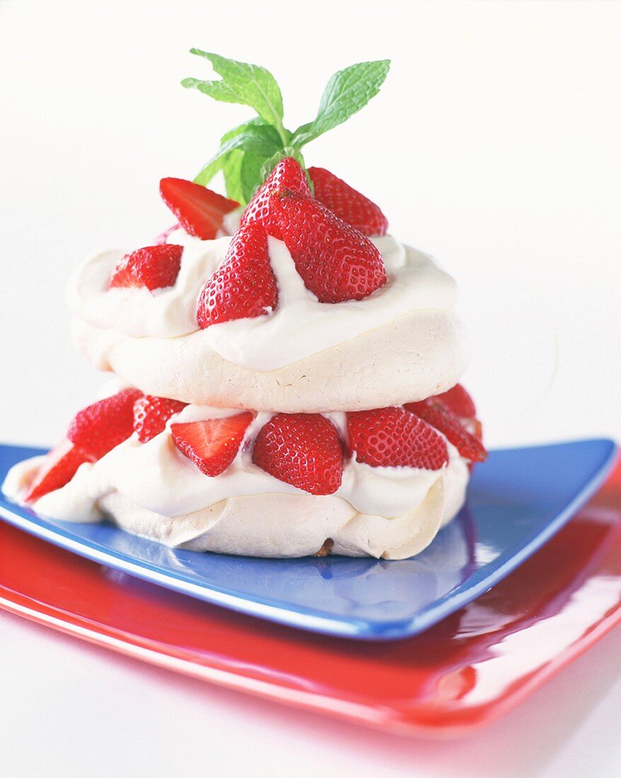Meringue with strawberries and mint leaves