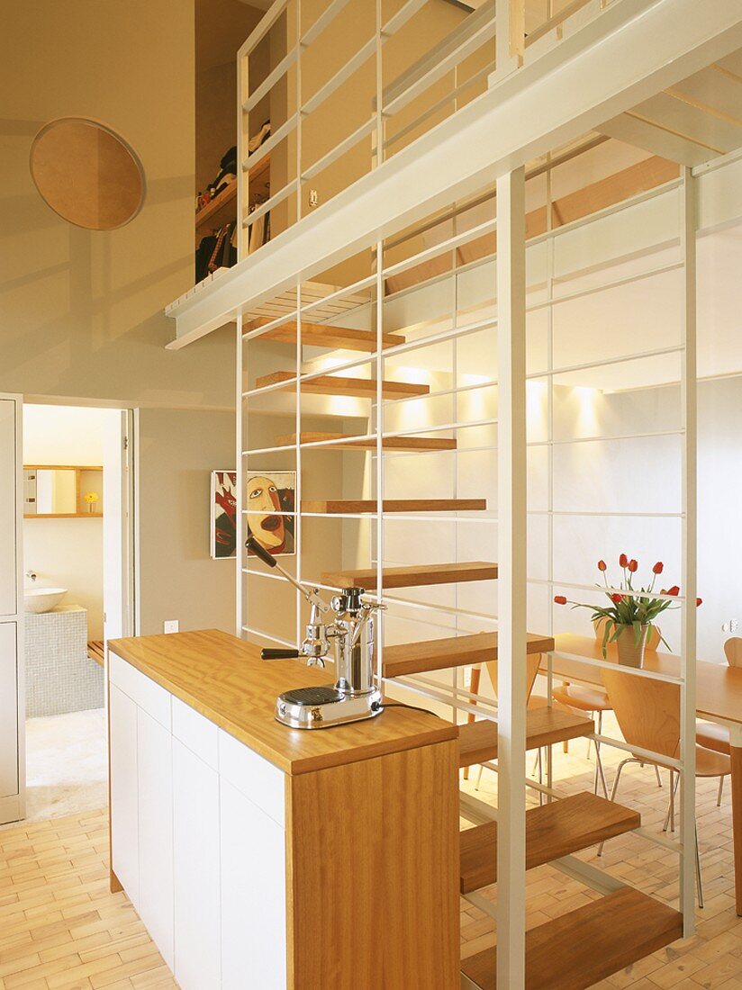 Kitchen with staircase leading to mezzanine