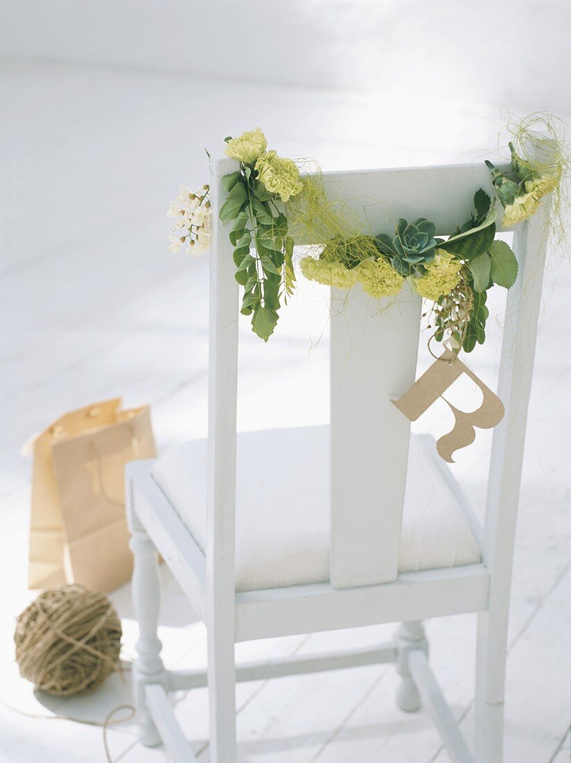Garland of plants on chair backrest