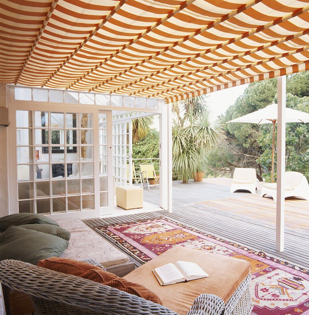 Chaise and rugs on roofed veranda