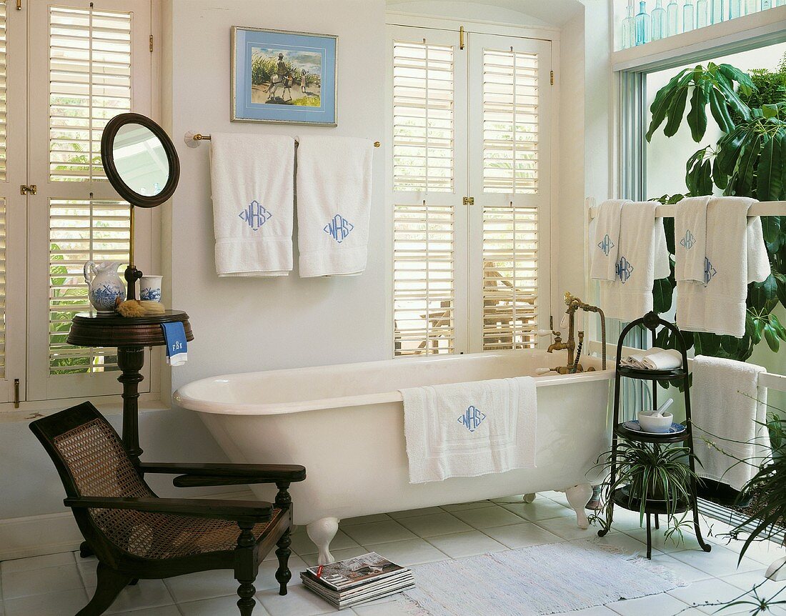 Bright bathroom with free-standing bathtub and antique furniture