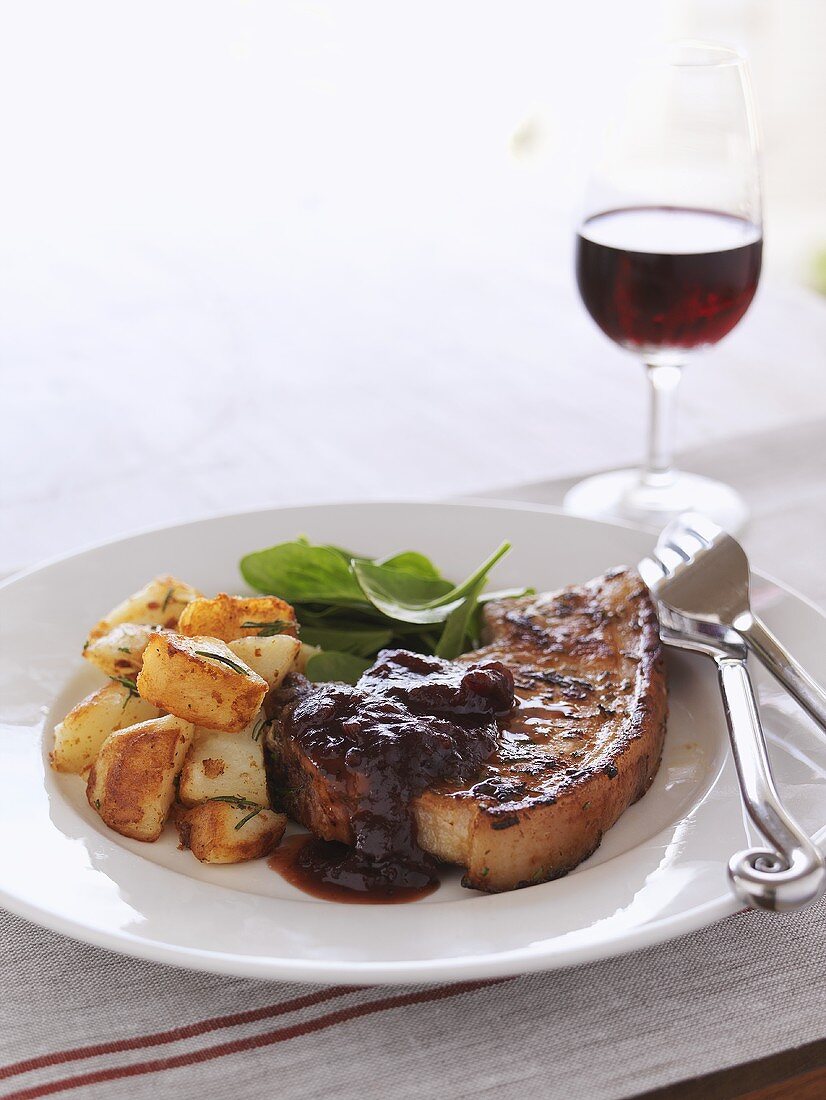 Fried belly pork with potatoes and cranberry sauce