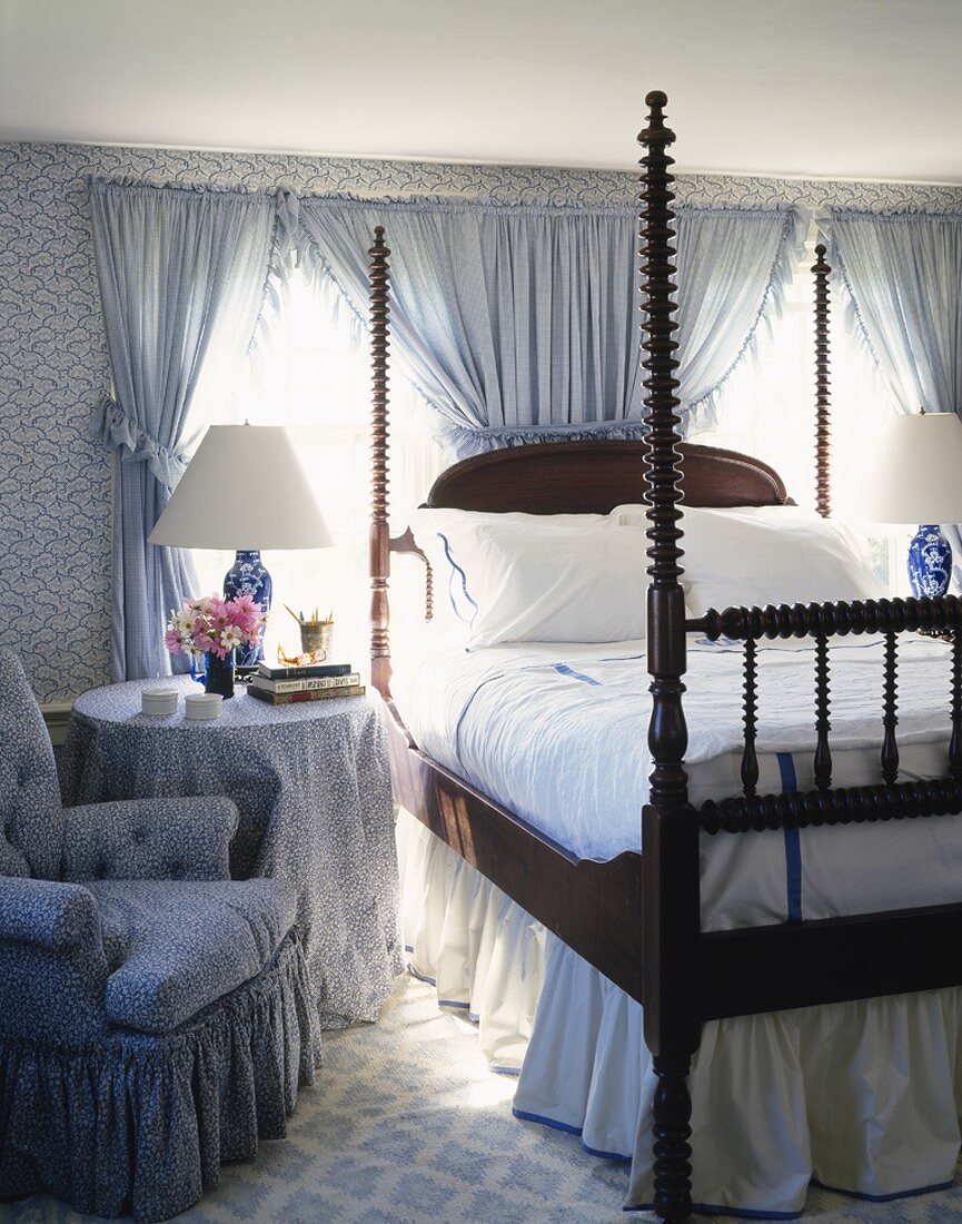 Grand bedroom with elaborately turned corner posts and blue and white textiles