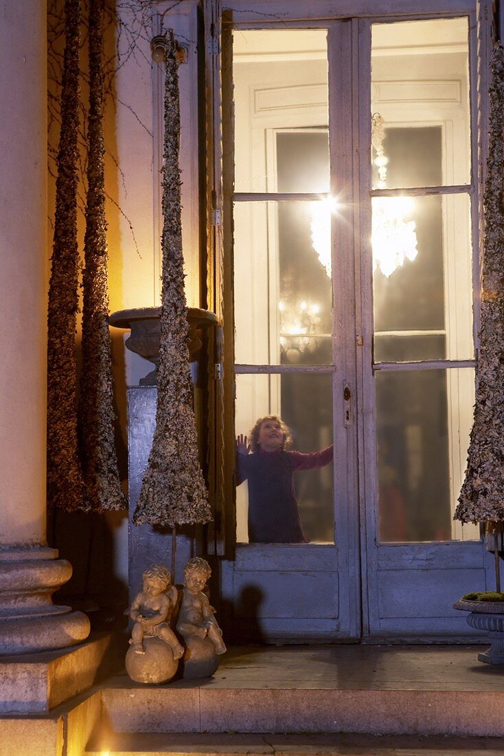 A girl standing at a window