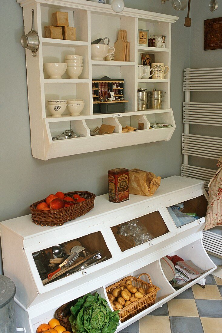 A kitchen floor cupboard with a wall-mounted shelf