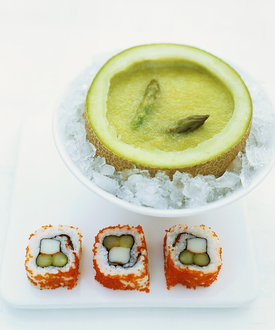 Chilled asparagus soup in melon half and inside-out sushi