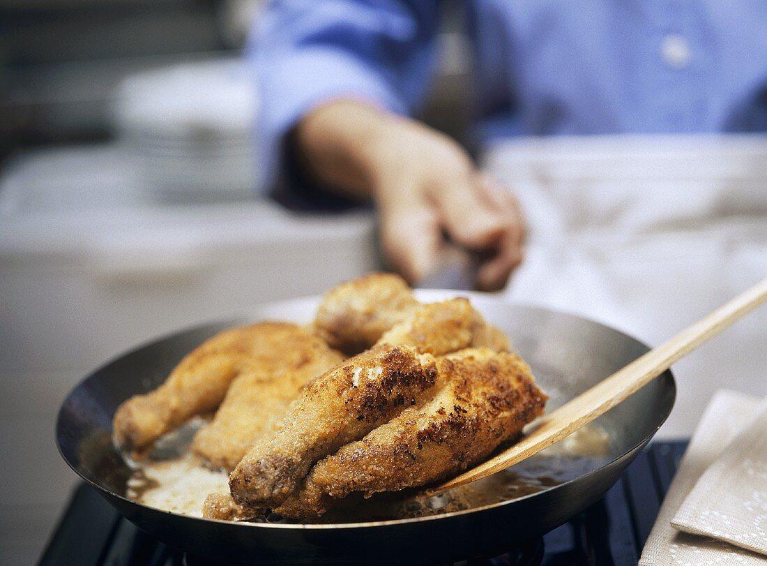 Frying chicken in a frying pan