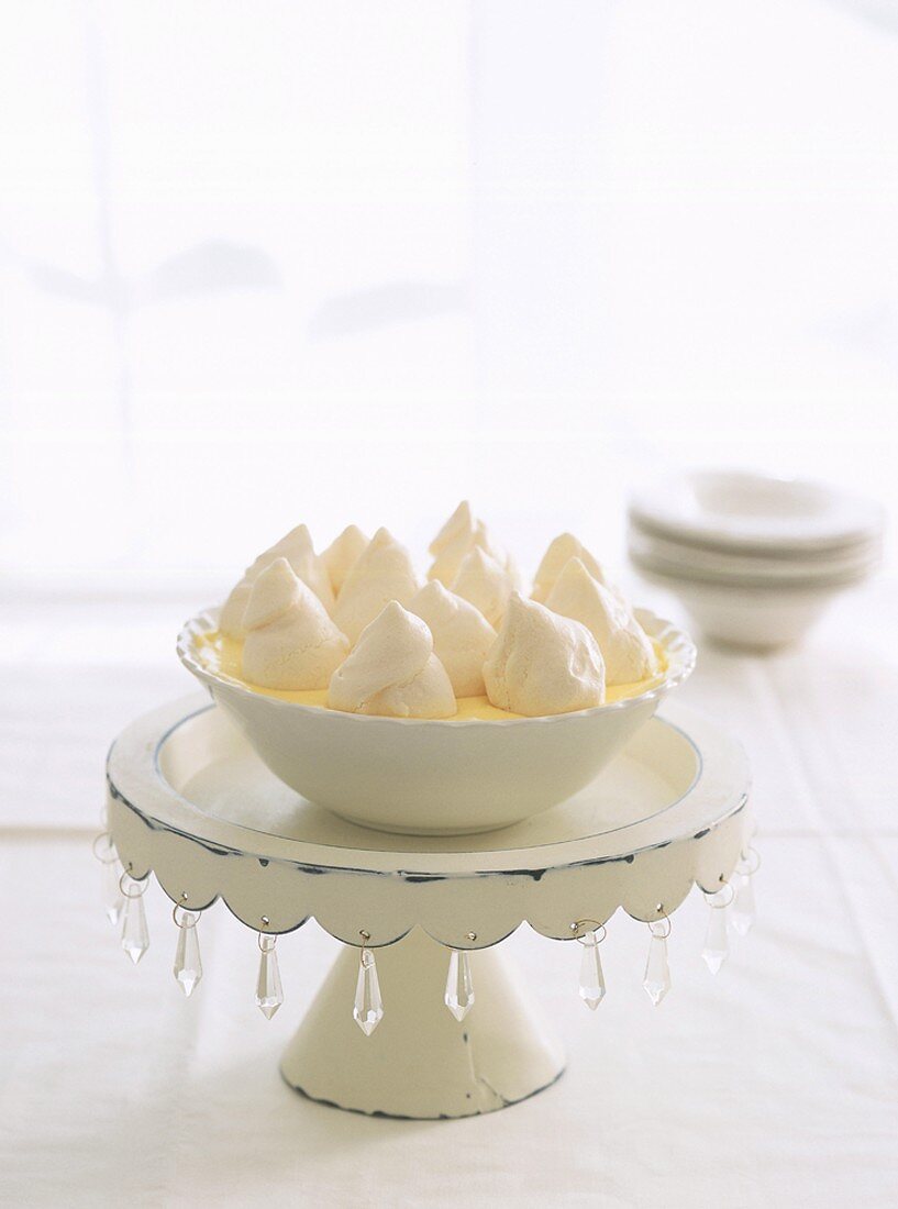 Vanilla cream with meringue on a cake stand for a wedding