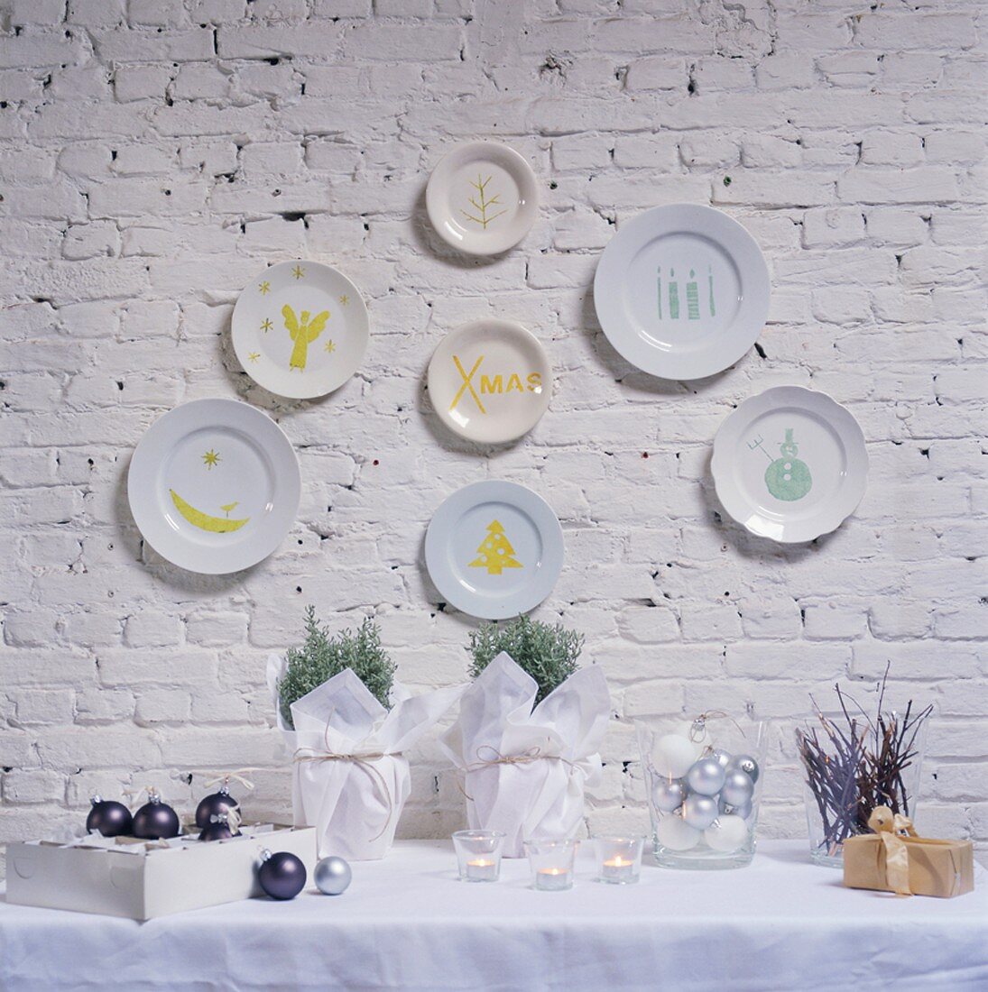 Christmas decoration on a table and hand-painted plates on a wall